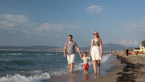 Young-family-walking-on-the-beach