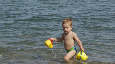 Adorable-little-boy-playing-in-the-sea