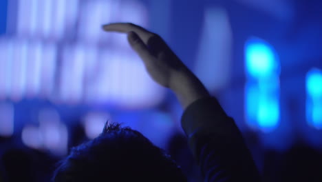 Music-fan-with-hand-up-at-the-concert