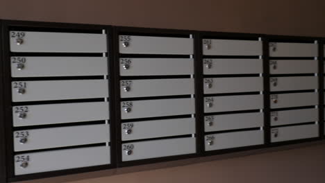 A-long-line-of-mailboxes-on-a-brown-wall
