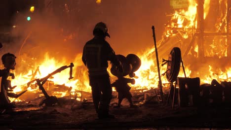 Firefighter-burning-ninots-in-the-fire-of-La-Cream-on-Fallas-celebration-Spain