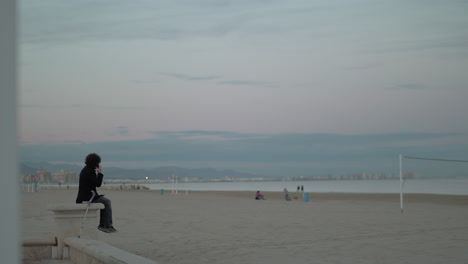 Man-talking-on-his-cellphone-beside-the-sea
