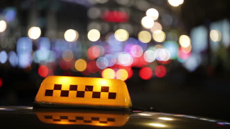 Illuminated-taxi-cab-sign-on-a-city-street