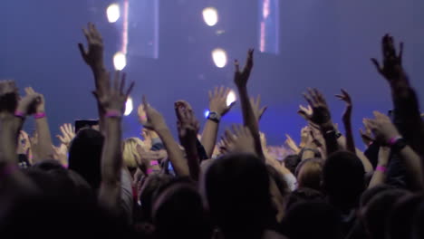 People-with-hands-up-at-the-rock-concert-view-with-stage-lights