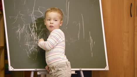 Creative-little-boy-drawing-on-a-chalkboard