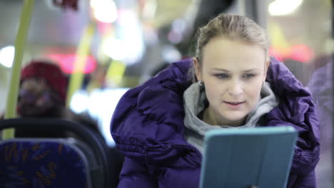 Woman-with-touchpad-in-the-bus