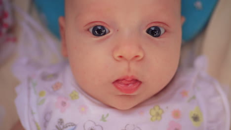 Portrait-of-three-months-baby-girl-with-big-blue-eyes