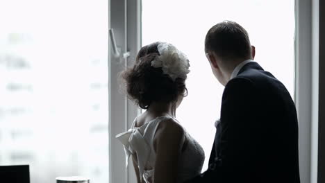 Bridal-pair-looking-out-the-window