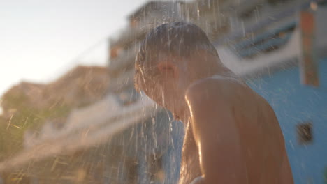 Kid-is-under-cool-beach-shower-outdoor