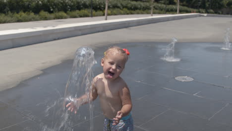 Little-kid-having-fun-with-fountain-jet