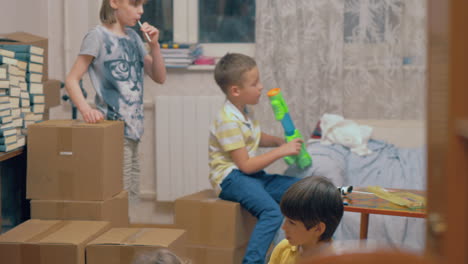 Group-of-kids-playing-among-boxes-at-home