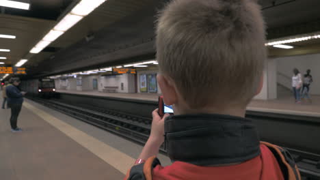 Child-making-his-own-photos-at-subway