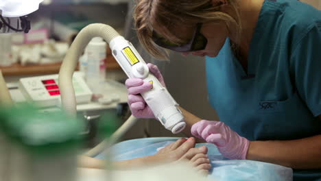 Woman-receiving-laser-treatment-on-her-feet