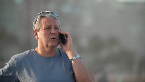 Gray-haired-man-with-phone
