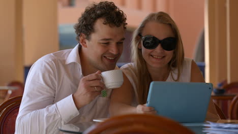 Loving-couple-in-cafe-with-touchpad