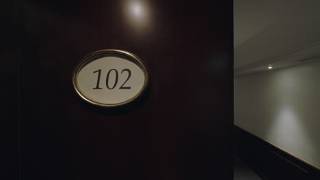 Empty-hotel-hall-and-room-number-sign