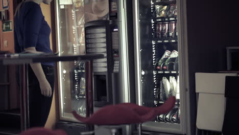 Woman-using-coffee-vending-machine