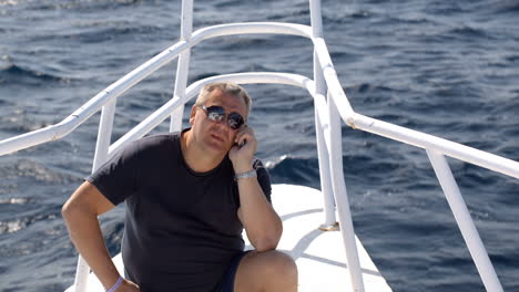 Phone-talk-on-sailing-yacht