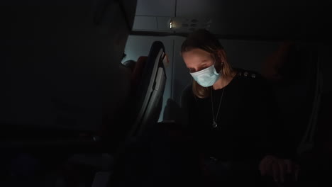 Woman-plane-passenger-using-phone-at-night