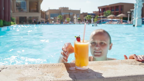 Woman-in-the-pool-with-juice