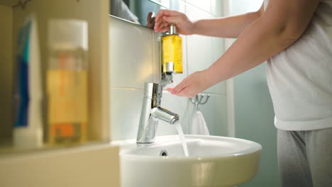 Woman-washing-hands-with-liquid-soap
