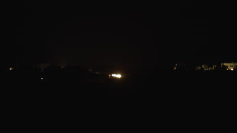 Pitch-black-night-and-few-cars-on-winding-country-road