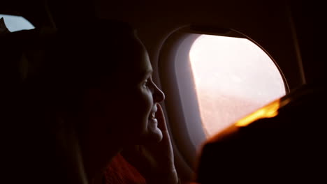 Woman-talking-on-the-phone-in-plane
