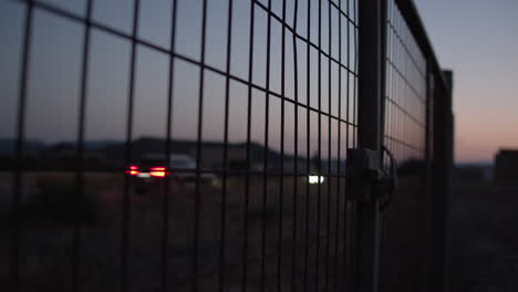 Wire-metal-fence-and-country-road-in-the-dusk