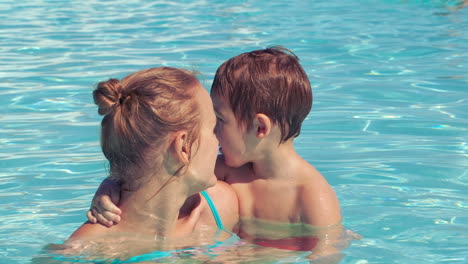 Mother-and-her-son-in-the-outdoor-swimming-pool