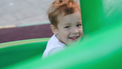 Happy-child-on-slide-outdoor