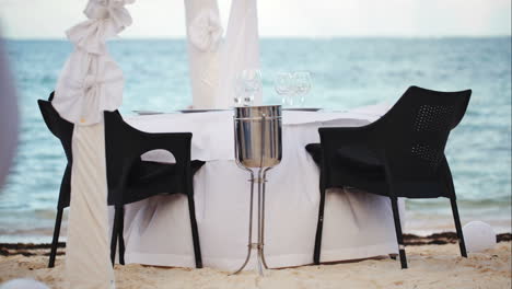 Served-empty-table-on-the-shore-in-black-and-white-colors