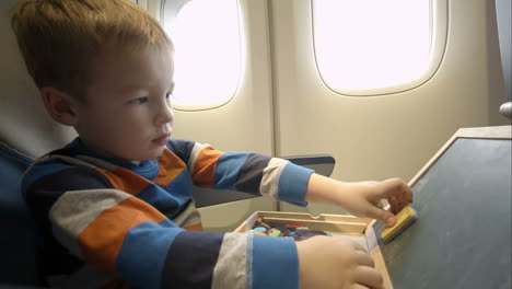 Little-boy-in-the-plane-with-wooden-box
