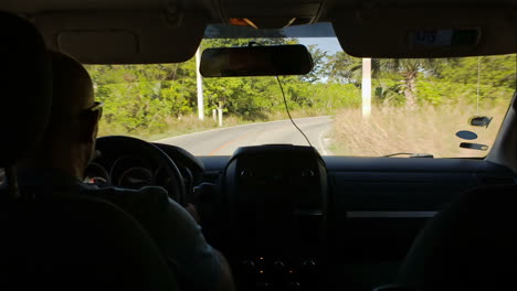 Timelapse-of-driving-a-car-on-road-with-a-lot-of-green-trees-around