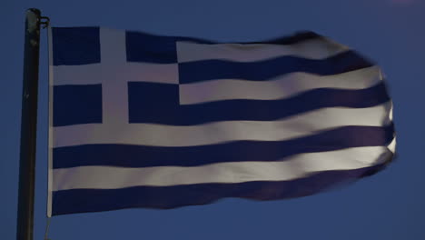 Greek-flag-fluttering-against-evening-sky