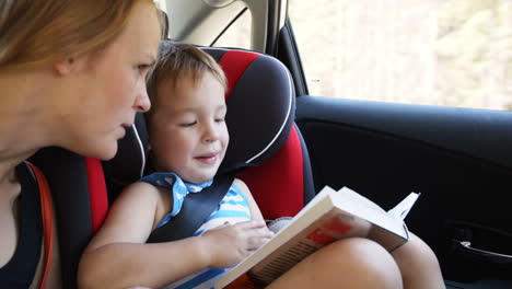 Mother-and-son-with-book-traveling-by-car
