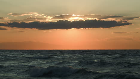 Rough-sea-and-evening-sun-hidden-with-cloud