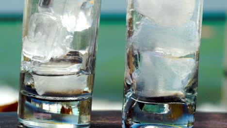 Pouring-water-into-glasses-with-ice