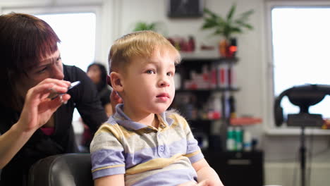 Child-getting-a-haircut-from-professional-hairdresser