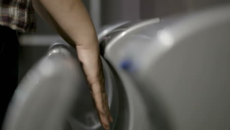 Woman-drying-hands-in-special-machine