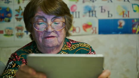 Senior-woman-using-touch-pad-and-talking