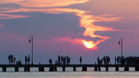 Timelapse-of-people-walking-on-pier-at-sunset