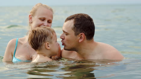 Lovely-family-with-child-bathing-in-sea