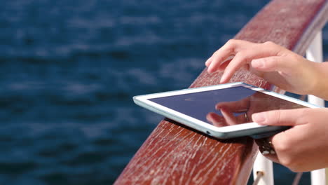 Woman-using-pad-while-traveling-by-sea