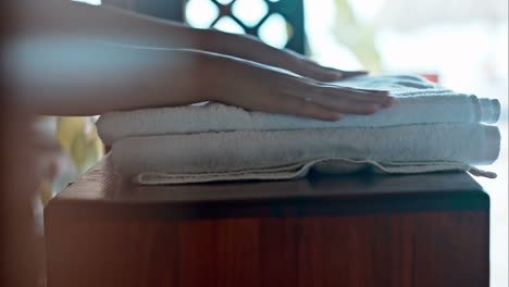 Putting-two-fresh-towels-on-small-table