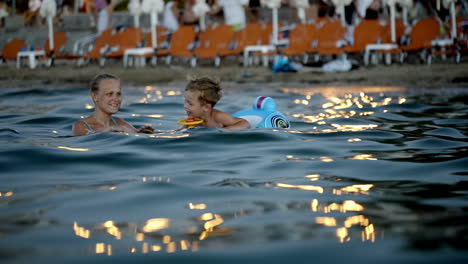 Mother-and-son-swimming-in-the-evening
