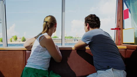 Young-couple-traveling-by-touristic-boat