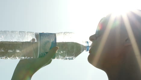 Woman-drinking-water-in-sunlight