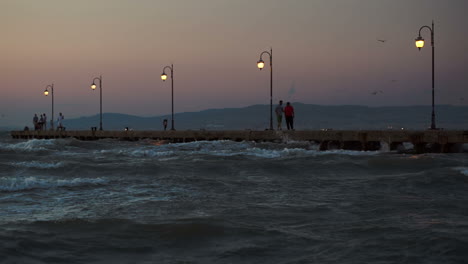 People-on-pier-in-the-windy-evening
