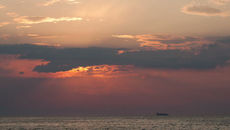 Zeitraffer-Des-Sonnenuntergangs-über-Meer-Und-Segelschiff