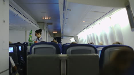 Stewardess-giving-drinks-to-passengers